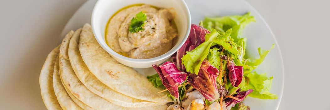 Hummus with tortillas on a white table. BANNER, LONG FORMAT