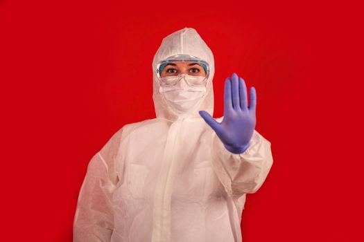 A doctor indicates stopping the spread of the COVID-19 virus. The concept of preventing the spread of the epidemic and treating coronavirus. Coronavirus treatment.