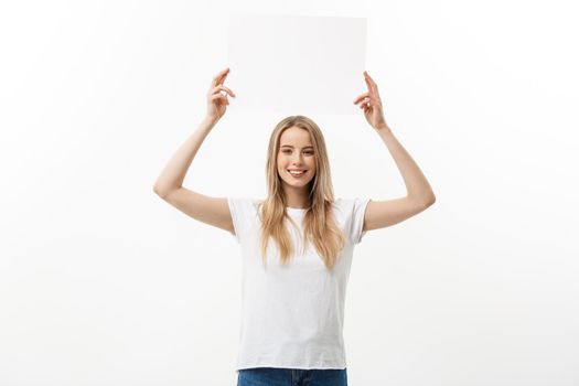 Blank sign. Woman holding empty blank white sign above her head. Excited and happy beautiful young woman isolated on white background