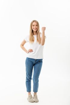 Full-length Portrait of a cheerful woman in white shirt and jean celebrating her success over white background.
