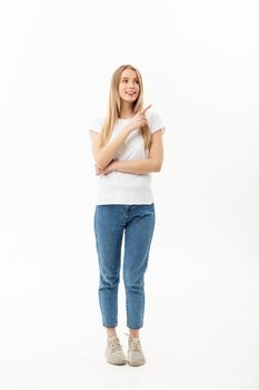 Young attractive happy woman in casual cloth pointing at white copy space background.