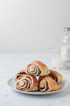 Sweet homemade poppy seed buns with milk for the breakfast