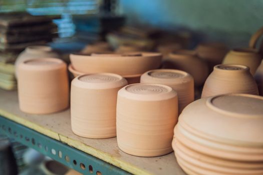 Cups on the shelves in the pottery workshop.