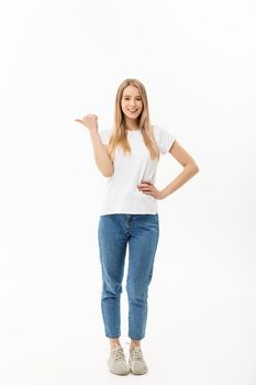 Young attractive happy woman in casual cloth pointing at white copy space background.
