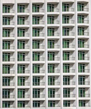 a repeating pattern of windows and a balcony. Windows of a hotel building.  