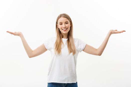 Portrait of young caucasian woman smiling and presenting two hands on side. Isolated on white background.