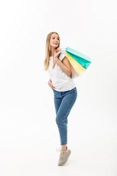 Full length of Shopper woman holding shopping bags standing happy smiling and excited in full body isolated on white background