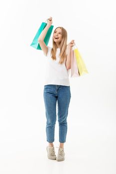 Full length portrait of a beautiful young woman posing with shopping bags, isolated on white background.