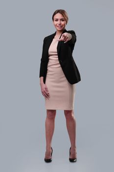 full length . young businesswoman pointing at you. isolated on white background