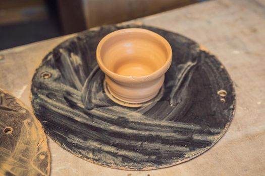 Cups on the shelves in the pottery workshop.