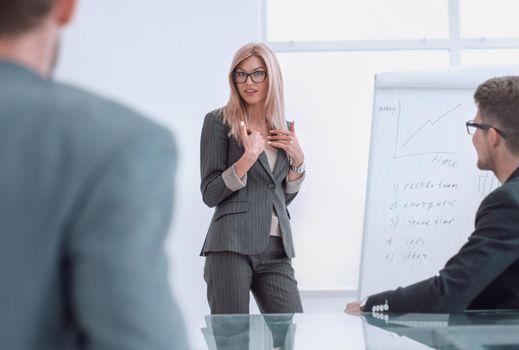 businesswoman makes a presentation of the new project in a spacious conference room