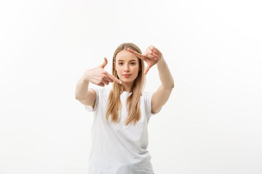 Portrait of young beautiful caucasian woman with cheerfuly smiling making a camera frame with fingers. Isolated on white background. Copy space