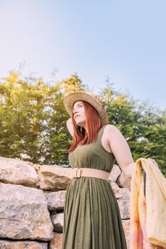 intrepid and adventurous young girl, having fun on her summer holiday. traveller walking at her vacation destination. trip, hobby, leisure, travelling tourist, outside, natural sunlight, vertical.