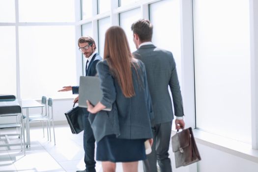 rear view.a group of business people walking in a new office . business concept