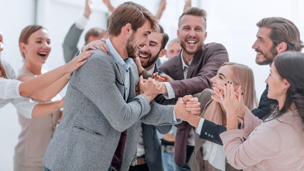 corporate group of employees applauding their colleague. photo with copy space