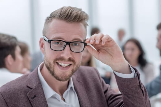 close up. confident young man standing in office. photo with copy space