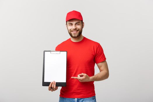 Delivery man in red uniform holding white empty blank paper isolated on white background. Copy space advertisement. Place for text or image.