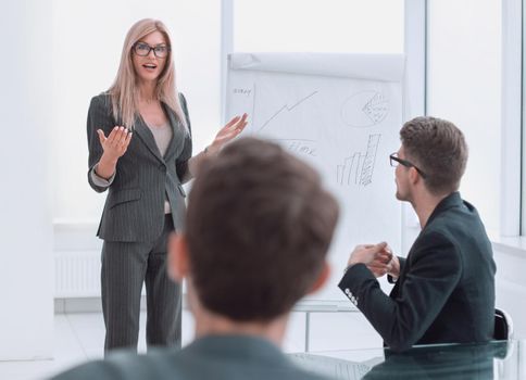 businesswoman makes a presentation of the new project in a spacious conference room