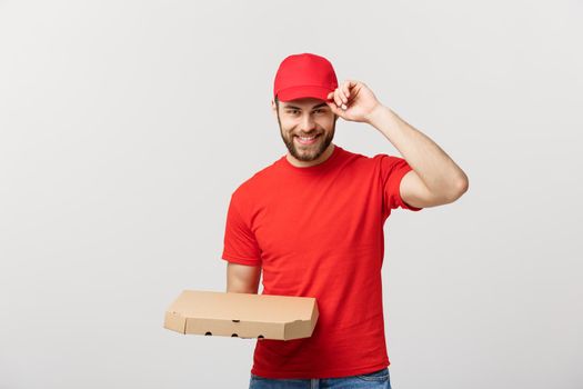 Delivery Concept: Young haapy caucasian Handsome Pizza delivery man holding pizza boxes isolated over grey background.