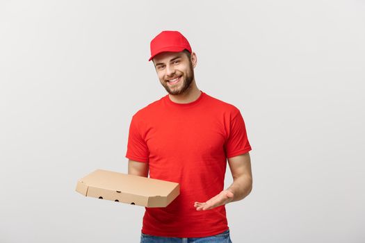 Delivery Concept: Young haapy caucasian Handsome Pizza delivery man holding pizza boxes isolated over grey background.
