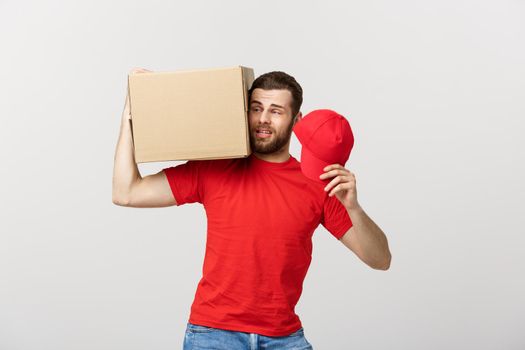 Delivery Concept: handsome Delivery man with boxes, delivery, courier with worry facial expression. Isolated grey background