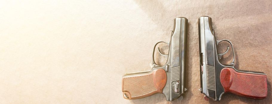 The gun lies on a table on old village boards, legalization of weapons. Crime problems. Weapons for sports and self-defense. Conceptual of violence, homicide, crime and burglary. Copyspace