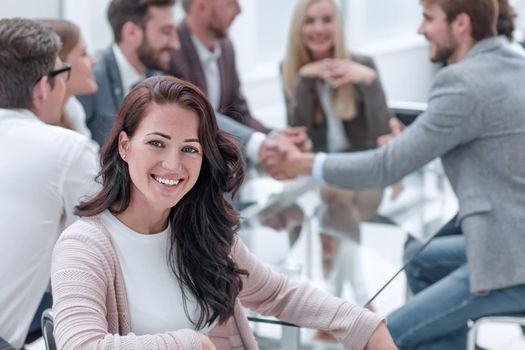 smiling business woman sitting in front of the table in the meeting room. business concept