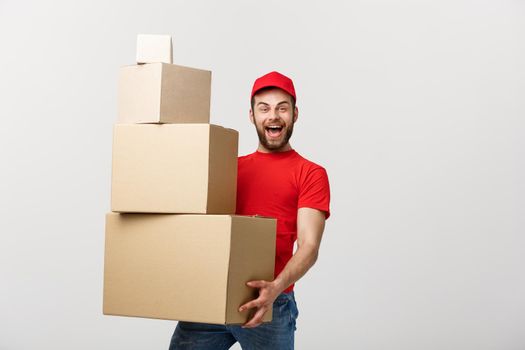 Delivery man doing surprise gesture holding cardboard boxes