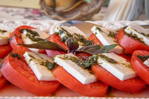Traditional Italian Caprese salad on the plate. Close view. 