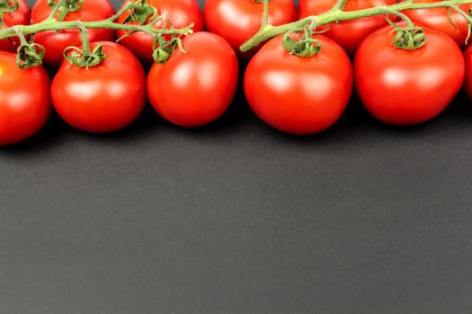 Red tomatoes on white plate with water drops