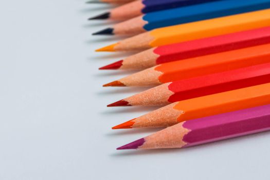 Row of multicolored wooden pencil collection isolated on white background