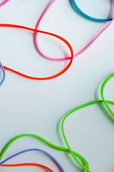 Top view of colorful rubber bands isolated on white. Rainbow elastic rubber bands on white. Space for text