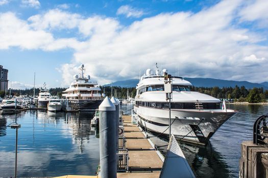 Many variety of yachts moored in a marina near Stanley park in Vancouver BC., Canada.