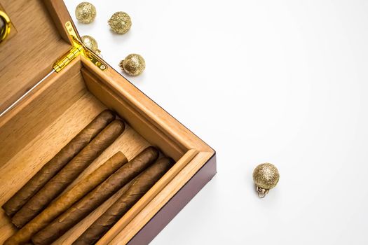 Opened humidor with cigars isolated on white background. Side view