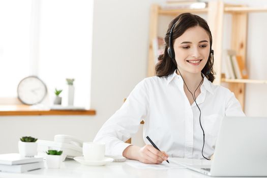 Call Center Concept: Portrait of happy smiling female customer support phone operator at workplace