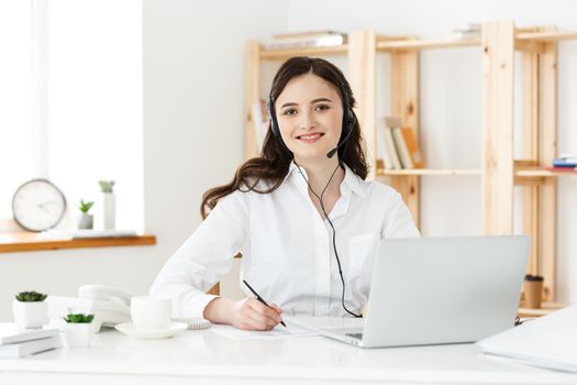 Call Center Concept: Portrait of happy smiling female customer support phone operator at workplace