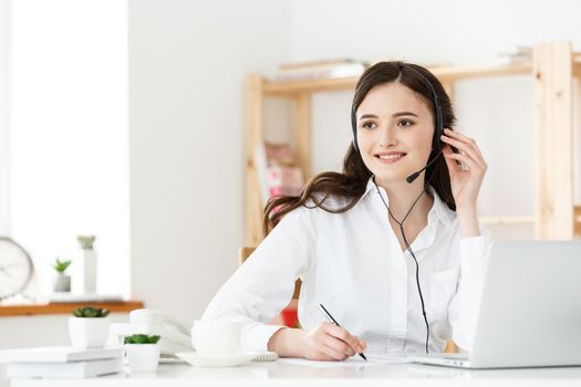 Call Center Concept: Portrait of happy smiling female customer support phone operator at workplace