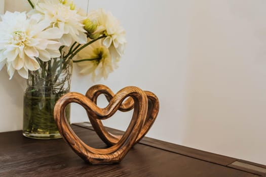 Two handmade wooden carved hearts on a table. Valentine day concept