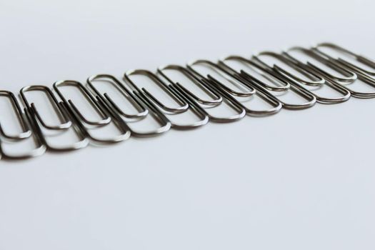 Metal paper clips on white