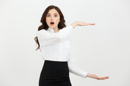 Business woman happy and surprise showing product .Beautiful girl holding hand to the side.