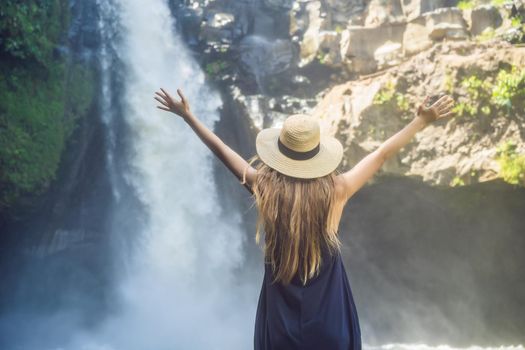 Woman traveler on a waterfall background. Ecotourism concept.