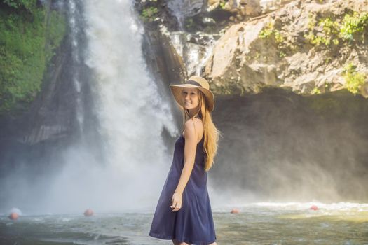 Woman traveler on a waterfall background. Ecotourism concept.