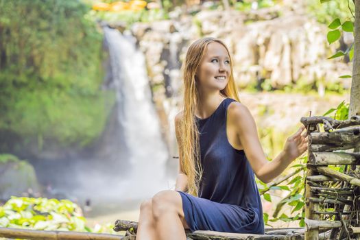 Woman traveler on a waterfall background. Ecotourism concept.