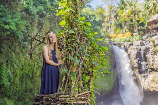 Bali trend, straw nests everywhere. Young tourist enjoying her travel around Bali island, Indonesia. Making a stop on a beautiful hill. Photo in a straw nest, natural environment. Lifestyle.