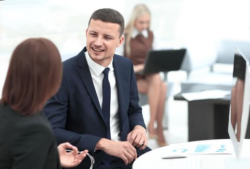 Manager talking with a colleague at the workplace . photo with copy space