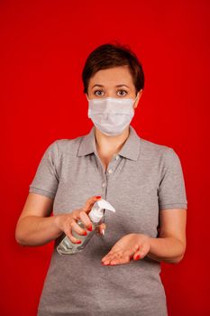 A woman uses a gel, disinfectant, antiseptic. Hand sanitizer prevents viral and plague infections, prevents the appearance of the Kovid-19 virus.