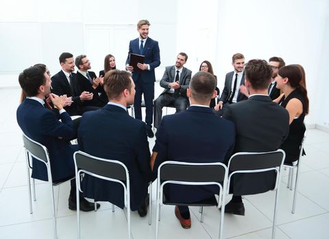 business people applauding the coach after the lecture . business concept