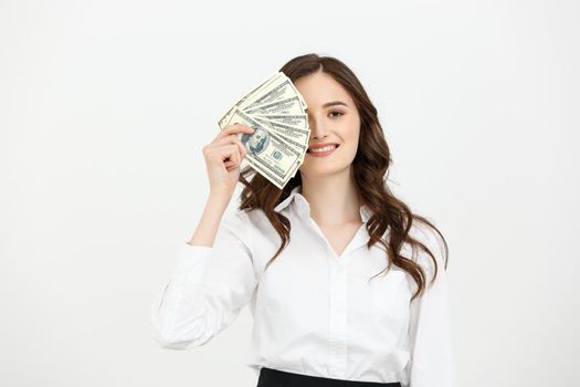 Young happy business woman with dollars in hand. Isolated on white background