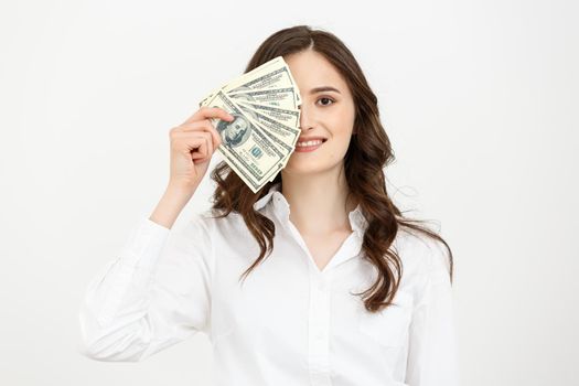 Young happy business woman with dollars in hand. Isolated on white background