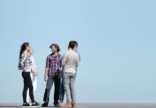 group of students talking while standing outdoors.photo with copy space